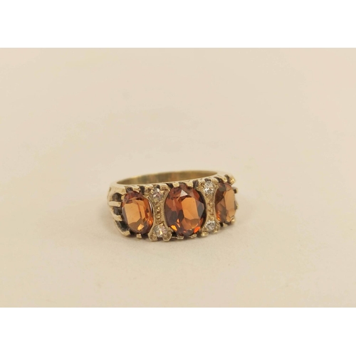 61 - Red spinel ring, another with square garnet and a citrine three stone ring, all 9ct gold. (3). 12.6g