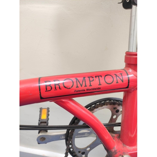 230 - Brompton three speed folding commuter's bicycle in red oxide paint.