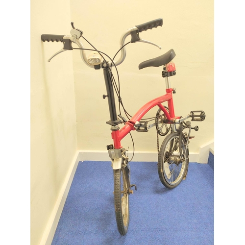 230 - Brompton three speed folding commuter's bicycle in red oxide paint.