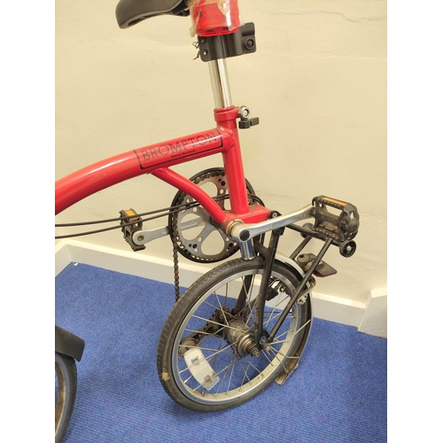 230 - Brompton three speed folding commuter's bicycle in red oxide paint.
