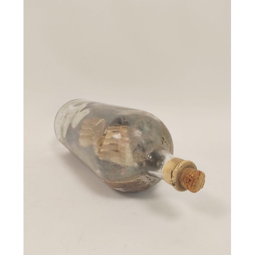 223 - Antique folk art naive ship in a bottle depicting a clipper ship against a harbour background.