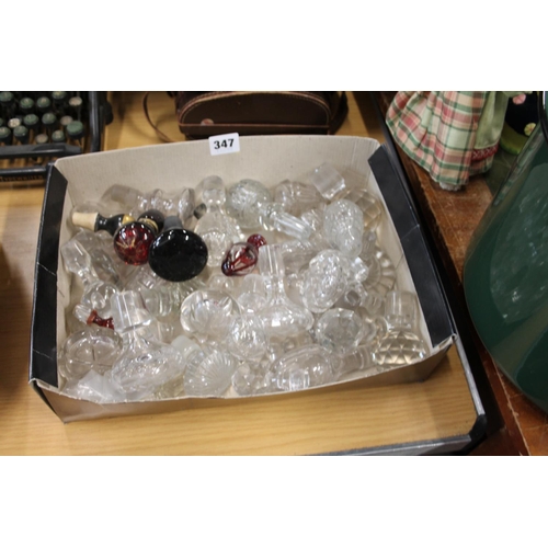 347 - Box containing decanter stoppers to include cranberry glass examples.