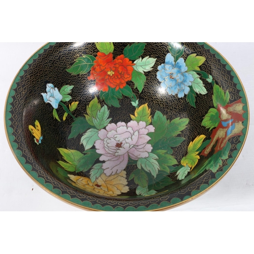 62 - Oriental cloisonne bowl decorated with flowers on black ground, 26cm.