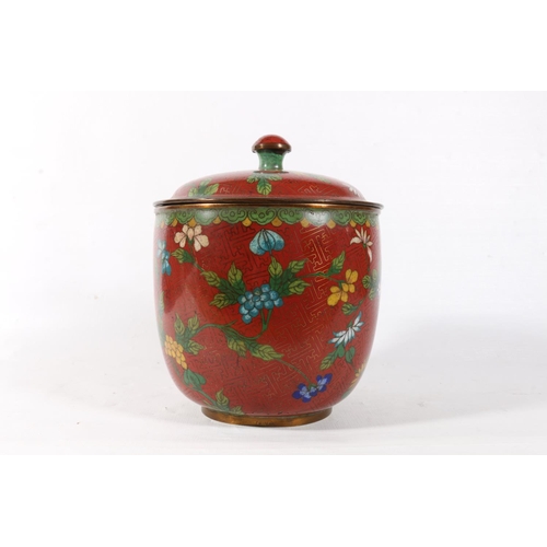 64 - Chinese cloisonne jar and cover decorated with flowers on a red ground, 17cm.