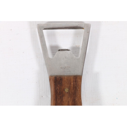 9 - Steel and treen bottle opener of fish form, in the manner of Carl Aubock, 15.5cm.