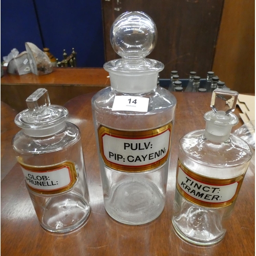 14 - Three antique glass apothecary bottles.