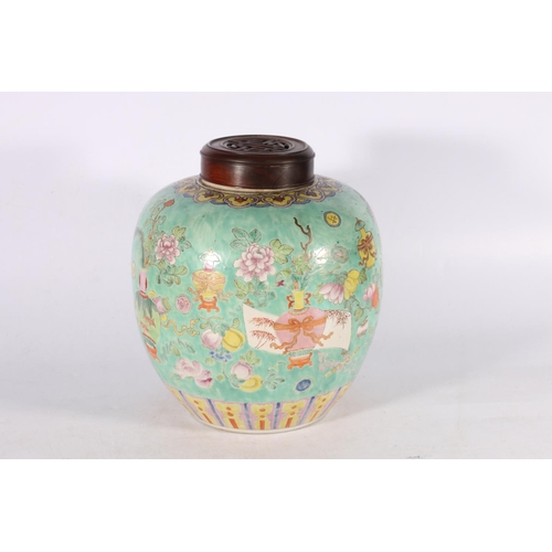 470 - A 19th century famille rose ginger jar and wooden cover, the body decorated with Buddhist and Daoist... 