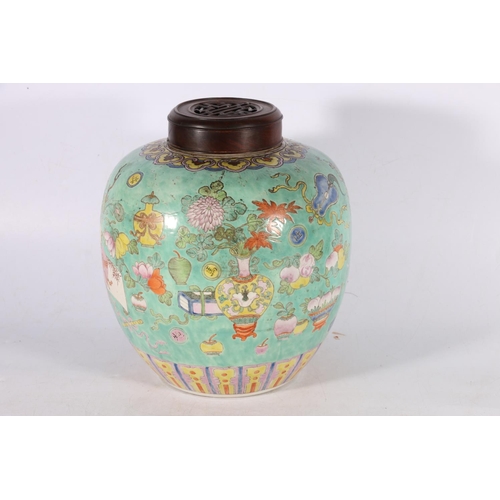 470 - A 19th century famille rose ginger jar and wooden cover, the body decorated with Buddhist and Daoist... 