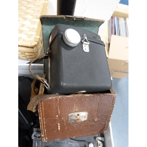 50 - Carton containing field glasses, folding camera, Brownie camera, Polaroid flash camera etc.