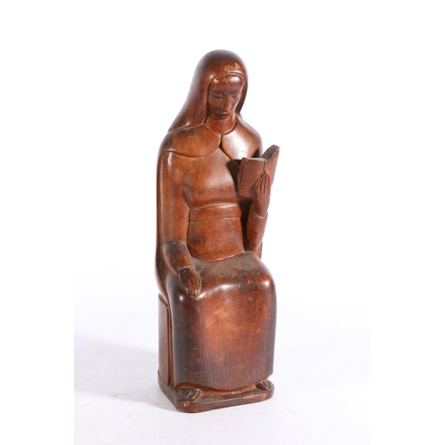 408 - CLARKE, a 20th century wood carving in the form of a nun seated at prayer holding a bible, incised s... 