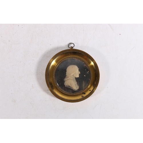 418 - J G HANCOCK, a carved wax profile portrait miniature of Reverend John Wesley, held within a gilt met... 