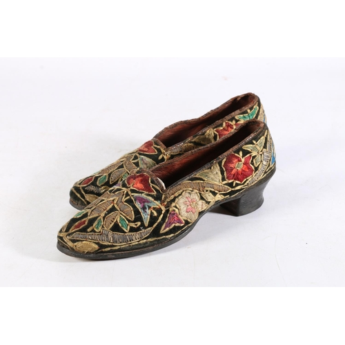 454 - Pair of antique Indian or Persian silk embroidered shoes with all-over floral decoration, 23cm long.