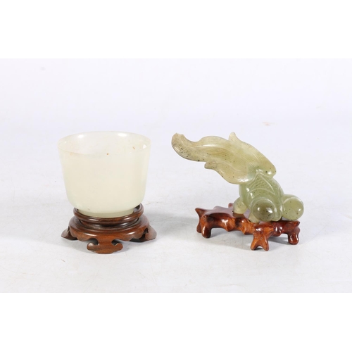 483 - Jade style cup on hardwood stand, 7cm diameter and a jade style fish model on hardwood stand, 7cm ta... 