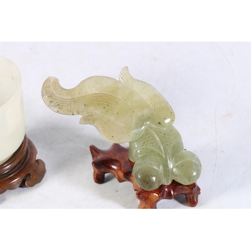 483 - Jade style cup on hardwood stand, 7cm diameter and a jade style fish model on hardwood stand, 7cm ta... 