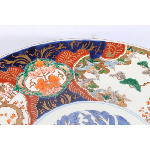 495 - Large Japanese imari charger with blue foliate decoration to central panel, 46cm diameter.