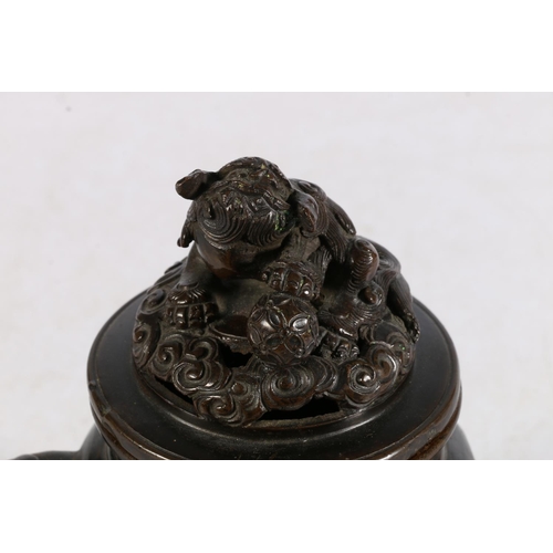 503 - Oriental bronze koro of typical form, the lid mounted with Dog of Fo, and Kylin head handles on trip... 