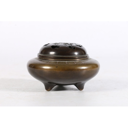 504 - Oriental bronze censor of squat form with pierced bronze lid and inlay to top of main body, 6.5cm ta... 