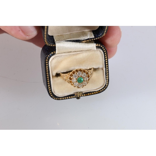 83 - Unhallmarked Victorian gold, diamond and emerald set flower-head ring, the central emerald surround ... 