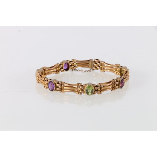 87 - 9ct gold amethyst and peridot set lady's bracelet, 17cm long, 14.3g.