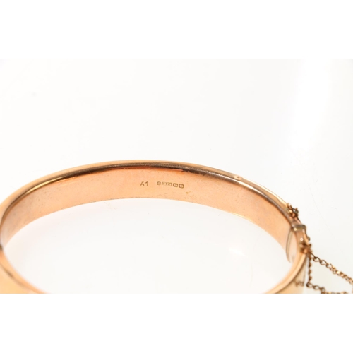 119 - 9ct rose gold half engraved foliate snap-shut bangle, 10.5g.