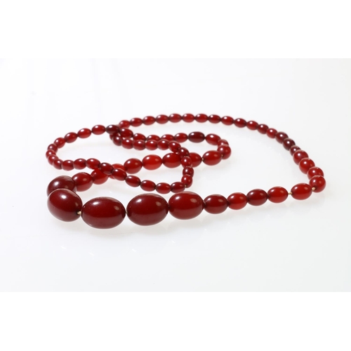 136 - Single strand of cherry amber beads, 78cm long, 48.3g.