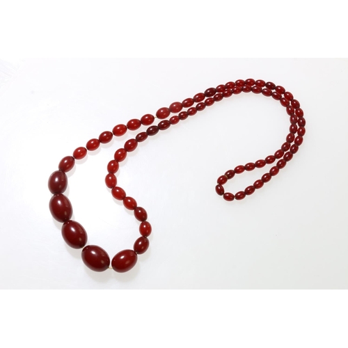 136 - Single strand of cherry amber beads, 78cm long, 48.3g.