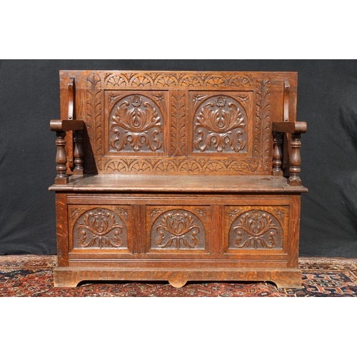 561 - Late Victorian carved oak monk's bench, raised on triple panel base, 112cm wide.