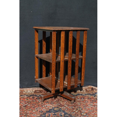 562 - Late Victorian oak revolving bookcase of typical design, 93cm high.