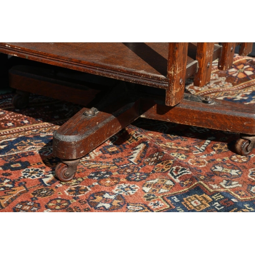 562 - Late Victorian oak revolving bookcase of typical design, 93cm high.