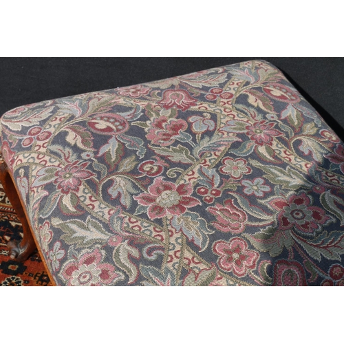 563 - Antique French style footstool, upholstered in floral patterned fabric, raised on carved rosewood ca... 