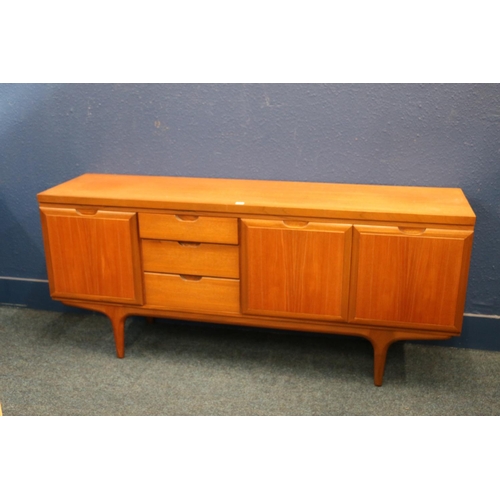 565 - Grieves & Thomas mid-century teak sideboard, having three graduated drawers flanked by cupboards... 