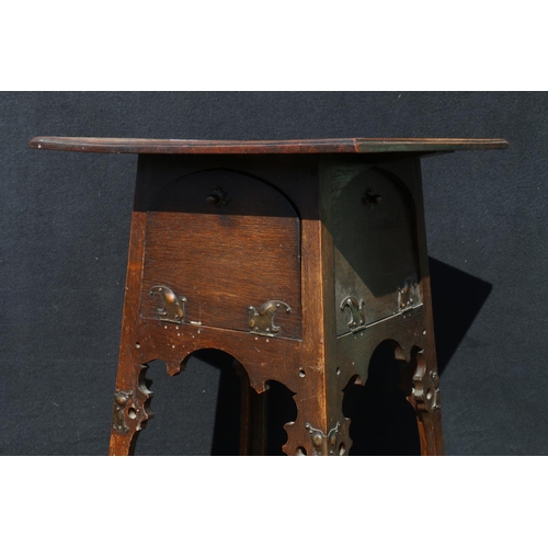 570 - Art Nouveau carved oak worktable, in the manner of Liberty's, the base with four fall front cupboard... 