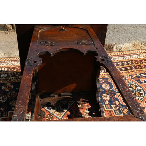 570 - Art Nouveau carved oak worktable, in the manner of Liberty's, the base with four fall front cupboard... 