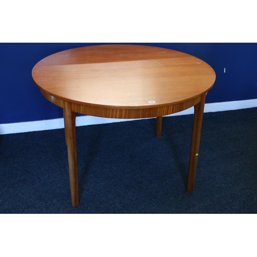 580 - Mackintosh of Kirkcaldy circular teak extending dining table, with collapsible leaf, raised on turne... 