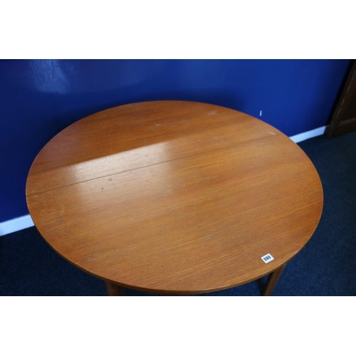 580 - Mackintosh of Kirkcaldy circular teak extending dining table, with collapsible leaf, raised on turne... 