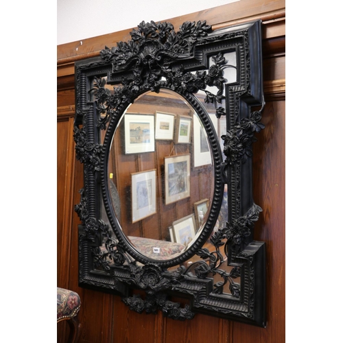 581 - Victorian style ornate wall mirror, having shell surmount and flower swags, 138cm x 99cm.