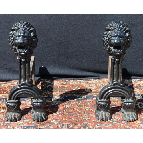 586 - Pair of Victorian anthropomorphic cast iron firedogs, with lion mask finials, raised on paw feet, 50... 