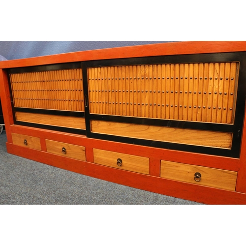 591 - Contemporary Japanese sideboard, having sliding door cupboard top and four base drawers, 183cm long.