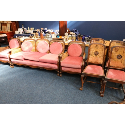 594 - Early 20th century seven piece oak framed single caned bergere parlour suite comprising a three seat... 