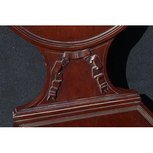 595 - Victorian mahogany hall chair, having knight and griffin finials on a shield shape back, with ribbon... 