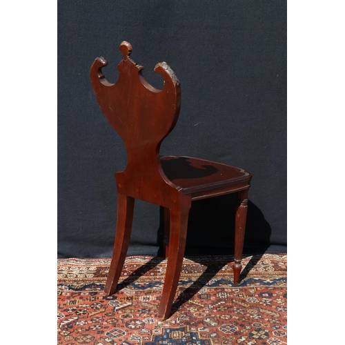 595 - Victorian mahogany hall chair, having knight and griffin finials on a shield shape back, with ribbon... 