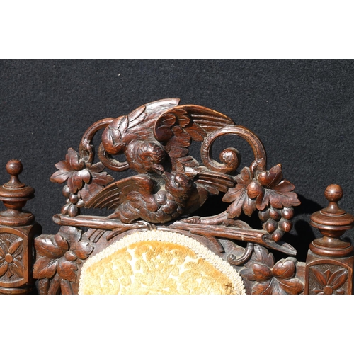 598 - Pair of carved oak Elizabethan style side chairs, the top rail modelled as a pair of birds and fruit... 