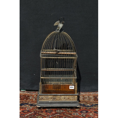 604 - Arts & Crafts French style bird cage of typical form, having inset glass panels, and repousse br... 