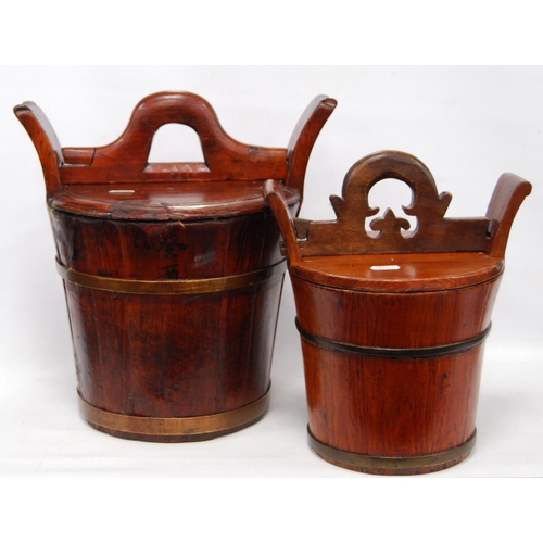 247 - Two Chinese stained wood rice carriers of bucket form, with covers, 33cm high, and another, smaller.... 