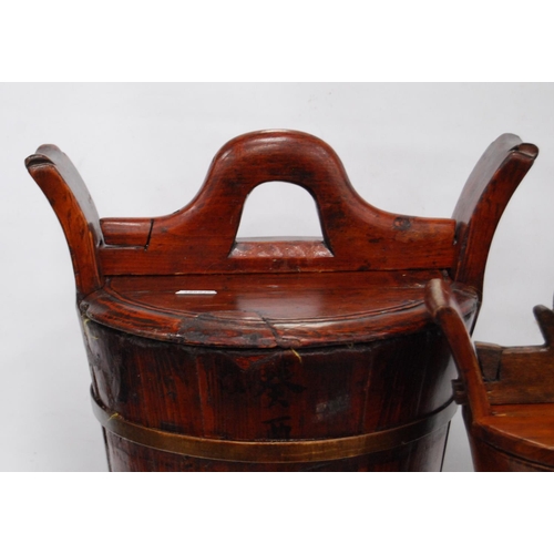 247 - Two Chinese stained wood rice carriers of bucket form, with covers, 33cm high, and another, smaller.... 