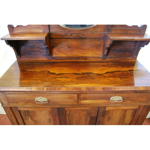 325 - Victorian rosewood chiffonier, the top section with an oval mirrored panel flanked by square shelves... 