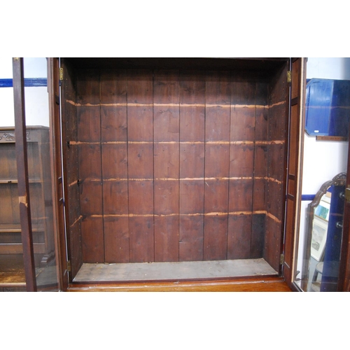 347 - Late Victorian mahogany library bookcase, the shaped cornice above two large glazed doors enclosing ... 