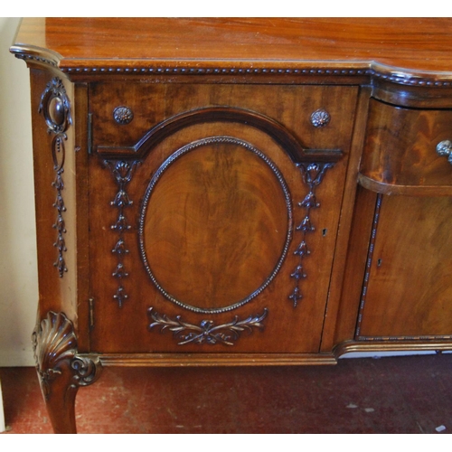 358 - Irish-style mahogany sideboard with shaped pediment above a large drawer and cupboard door flanked b... 