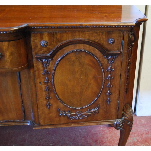 358 - Irish-style mahogany sideboard with shaped pediment above a large drawer and cupboard door flanked b... 