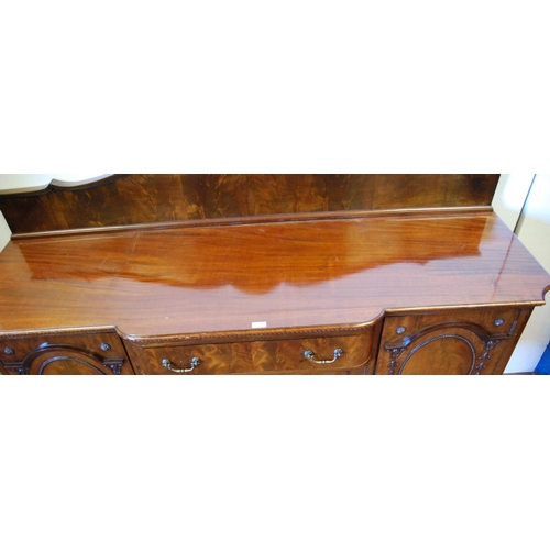 358 - Irish-style mahogany sideboard with shaped pediment above a large drawer and cupboard door flanked b... 